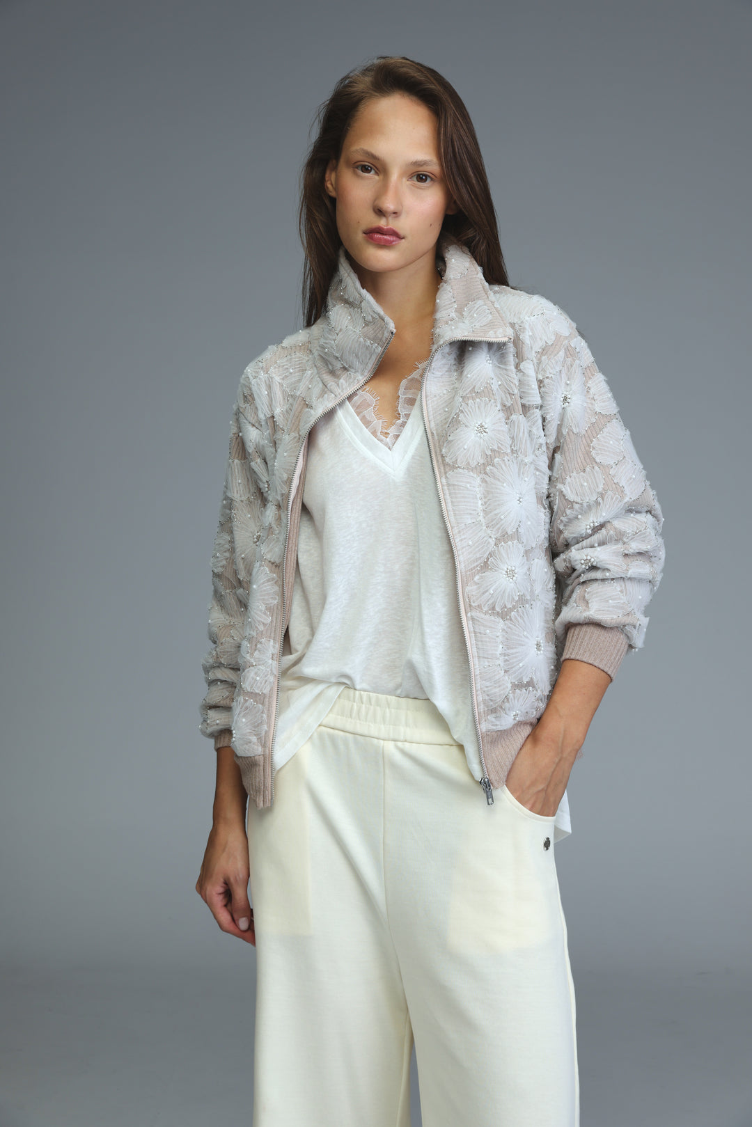 Light gray quilted bomber jacket with floral embroidery and subtle sheen shown from the front
