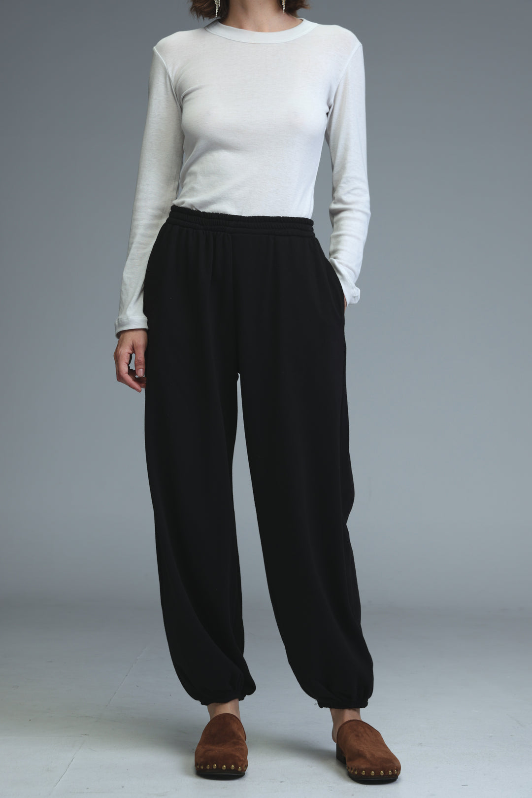 Black high-waisted wide-leg joggers with a relaxed silhouette and elastic cuffs shown from the front