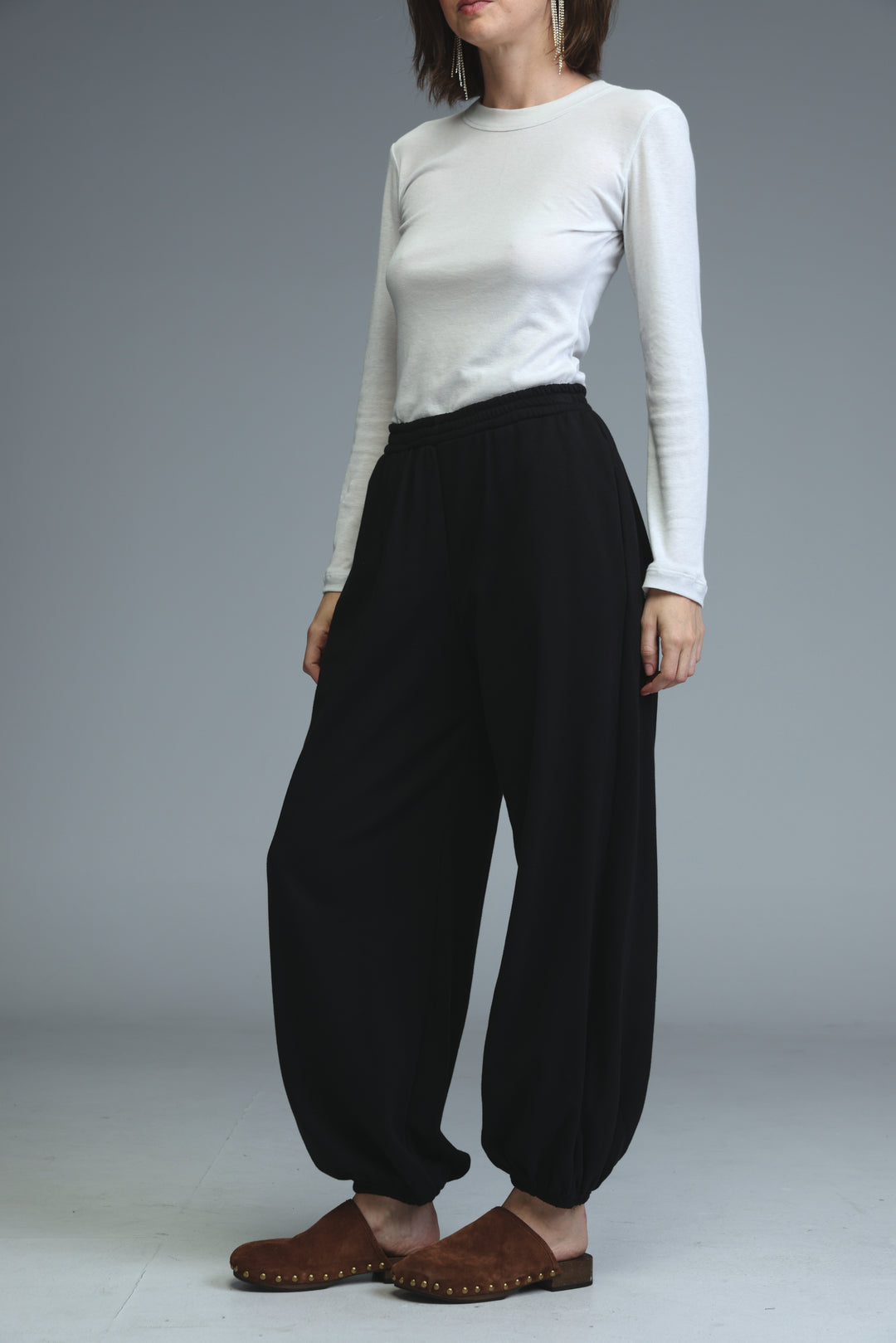 Black high-waisted joggers with wide legs and elastic cuffs shown from the front