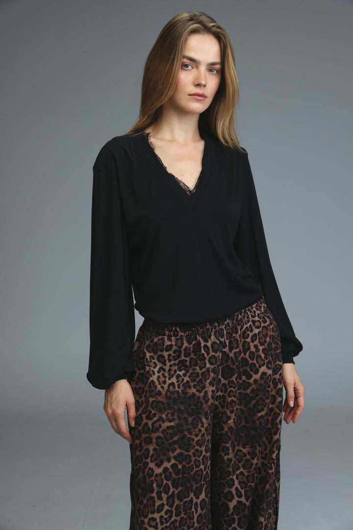 Black long-sleeved marry shirt with v-neckline and delicate lace trim along the edge front view