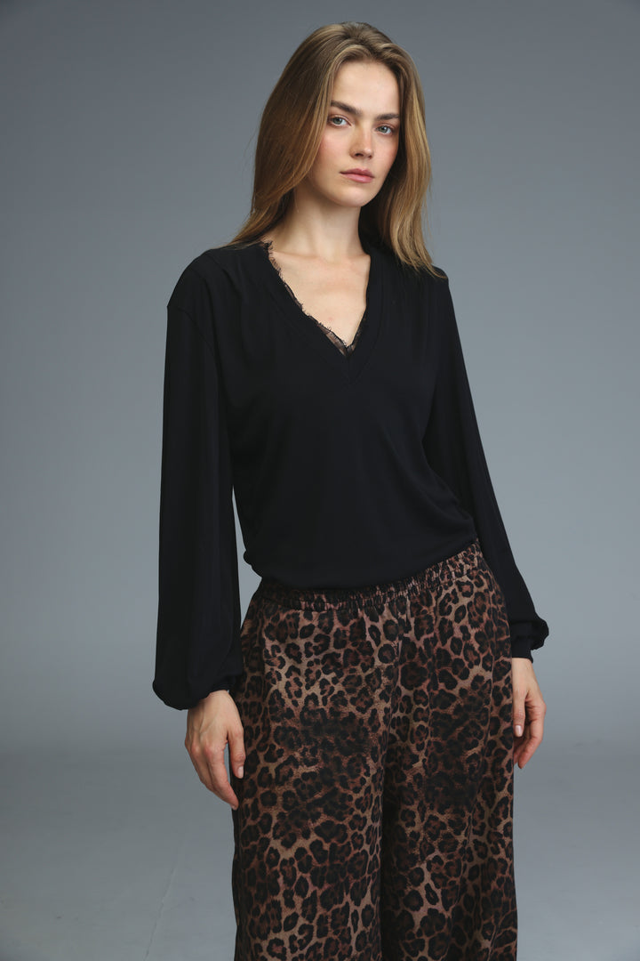 Black long-sleeved marry shirt with v-neckline and delicate lace trim along the edge, front view