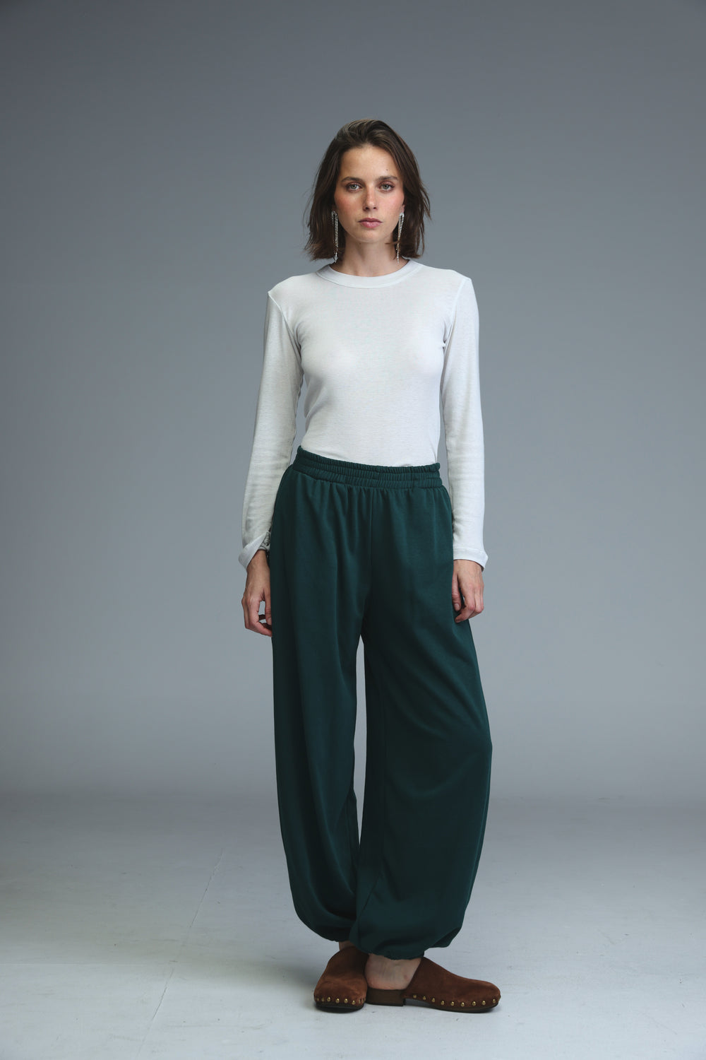 Dark green loose-fitting high-waisted joggers with soft drape and elasticated waistband front view