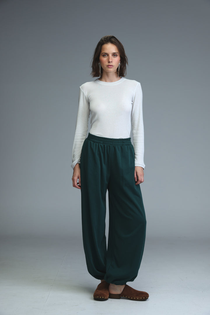 Dark green loose-fitting high-waisted joggers with soft drape and elasticated waistband front view