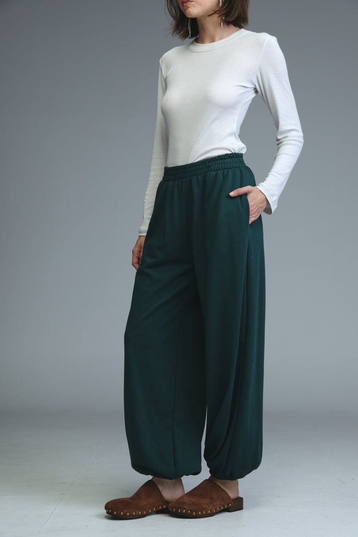 Dark green loose fitting wide leg pants with elastic waistband shown from the front in try green joggers product