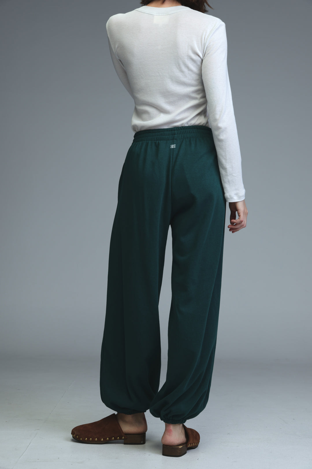 Dark green loose fitting jogger pants with elastic waistband shown from the front