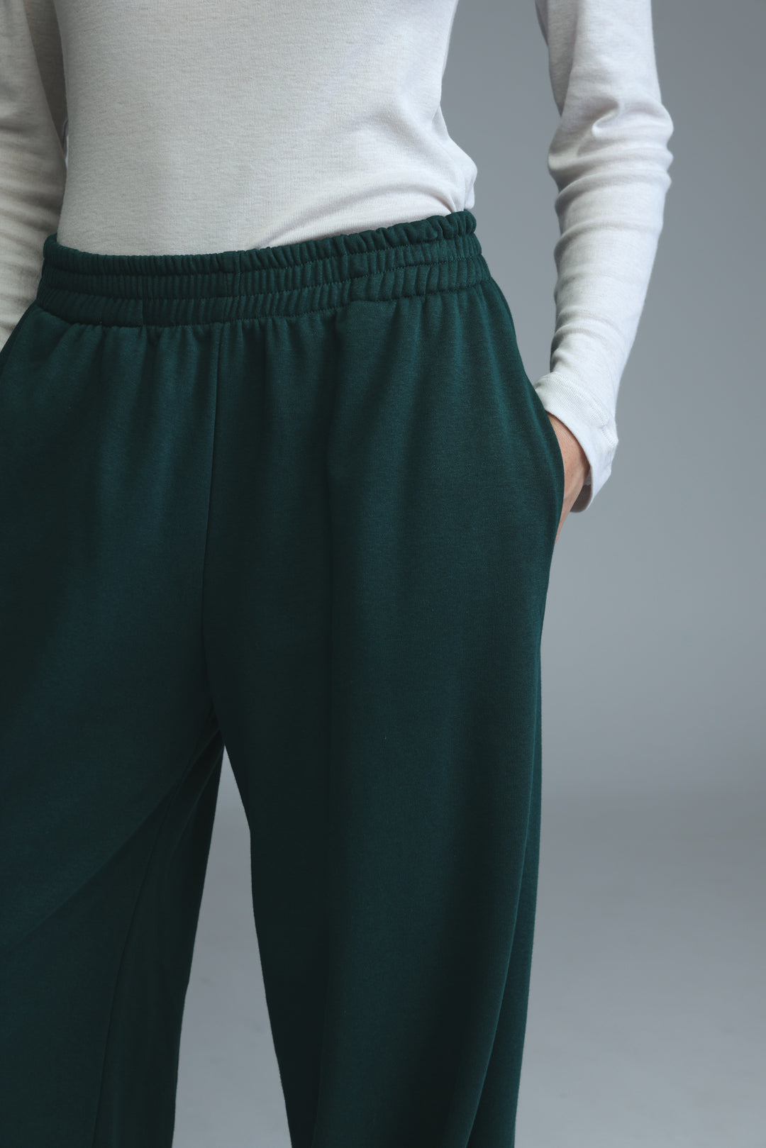 Dark green try green joggers with high-waisted elastic waistband and relaxed fit shown from the front