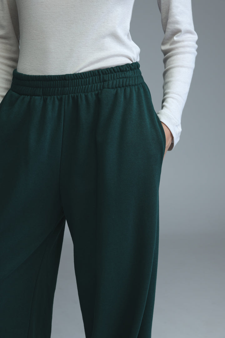 Dark green try green joggers with high-waisted elastic waistband and relaxed fit shown from the front
