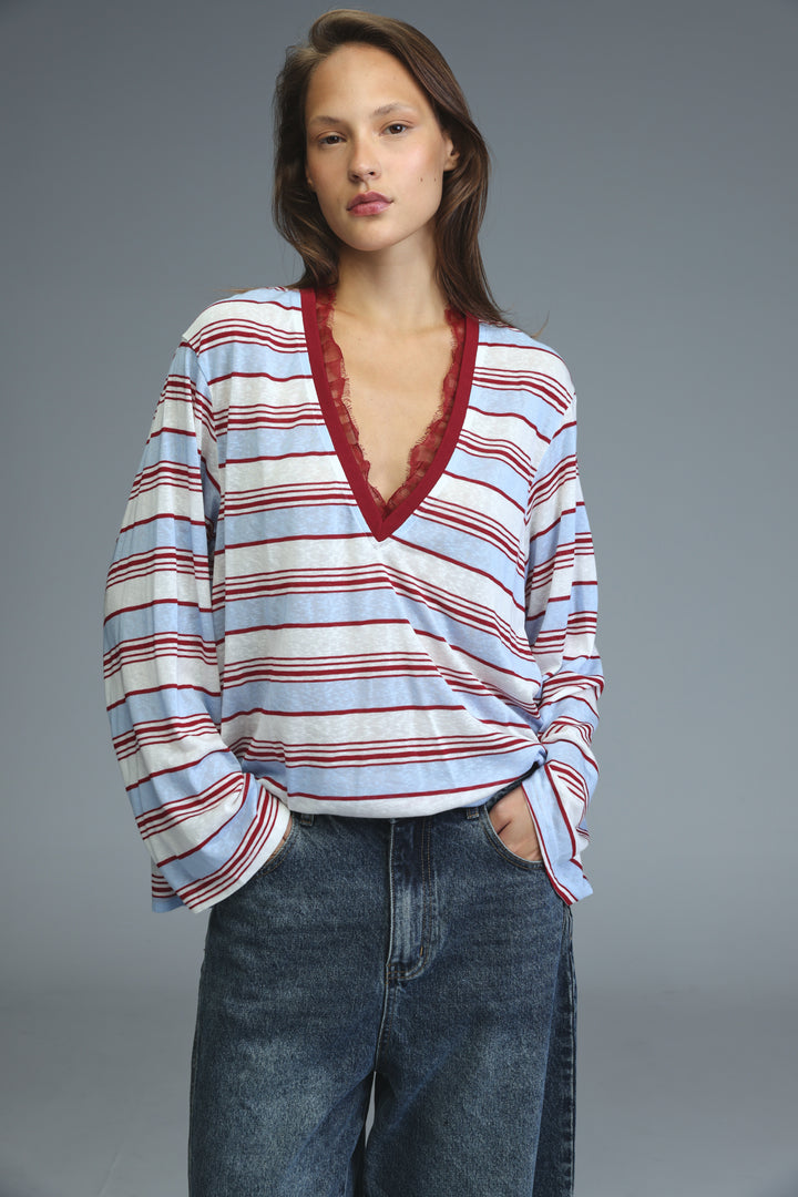 A glow red striped long-sleeved v-neck shirt with horizontal stripes and lace trim along the neckline
