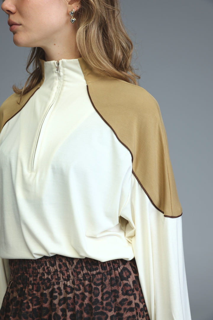Allure cream sweatshirt zip-up top in cream and camel with dark brown trim along front seams