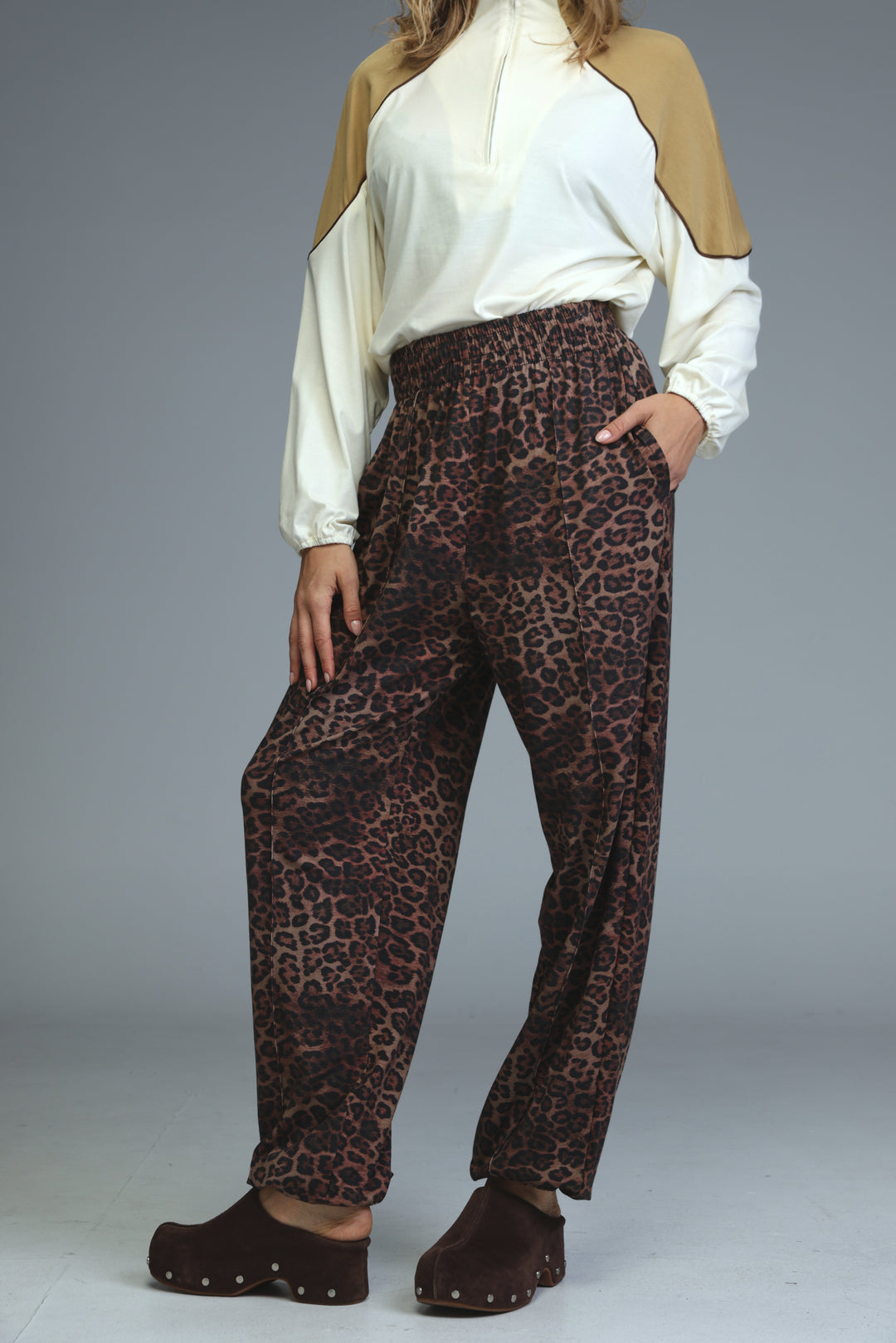 Brown leopard-print high-waisted joggers with relaxed fit and elastic waistband shown from the front