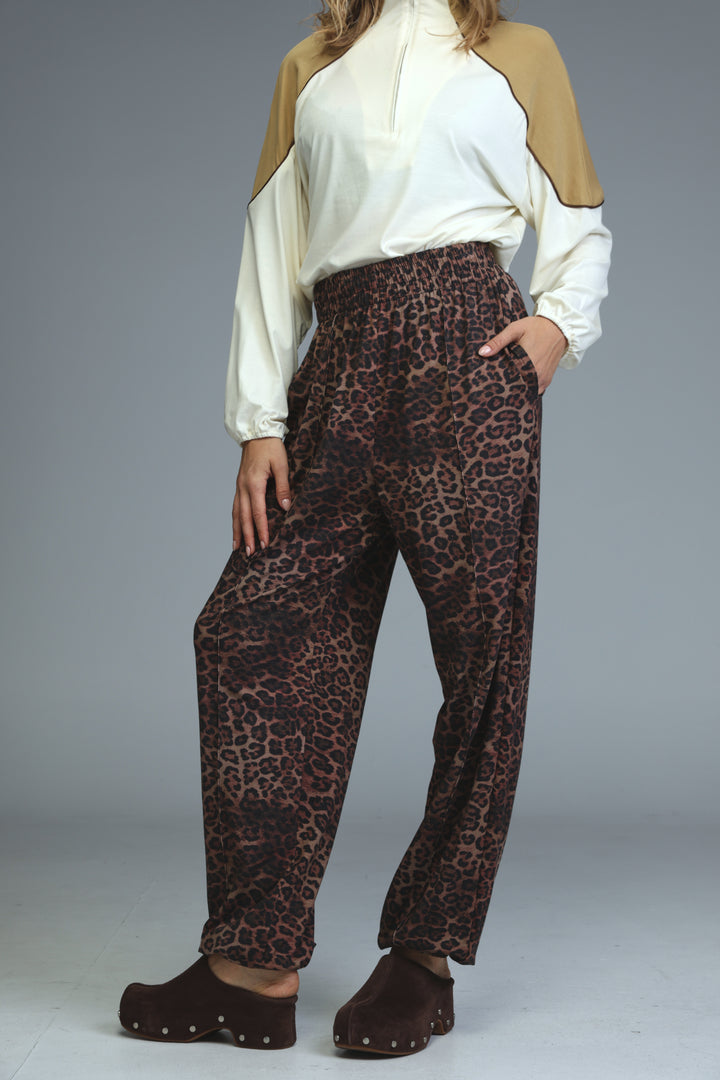 Brown leopard-print high-waisted joggers with relaxed fit and elastic waistband shown from the front
