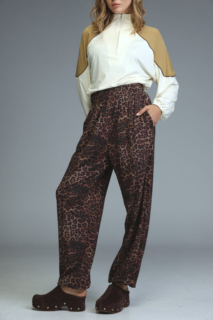 Brown leopard-print wide-leg trousers with elastic waistband shown from the front in best leopard joggers collection