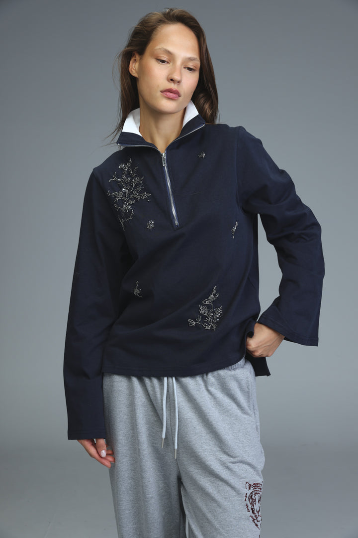 Navy blue half-zip sweatshirt with silver floral embroidery and white inner collar showing the front view