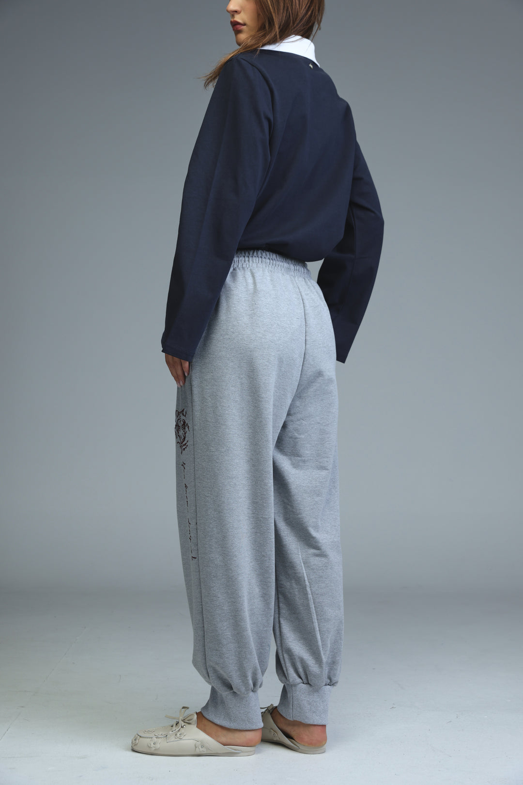 Iconic grey joggers with a subtle black embroidered logo on the left leg shown from the front