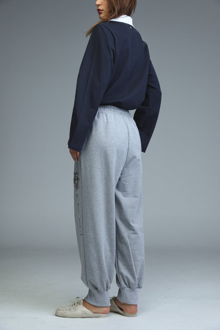 Iconic grey joggers with a subtle black embroidered logo on the left leg shown from the front
