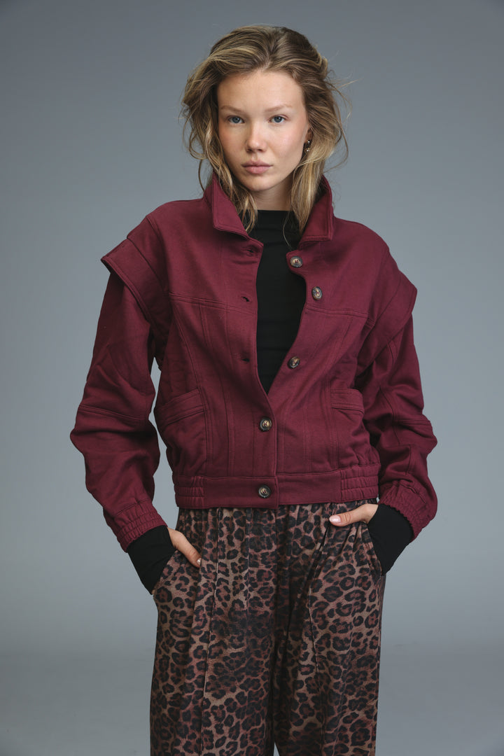 Maroon puzzle wine jacket front view with collar, button closures, and patch pockets