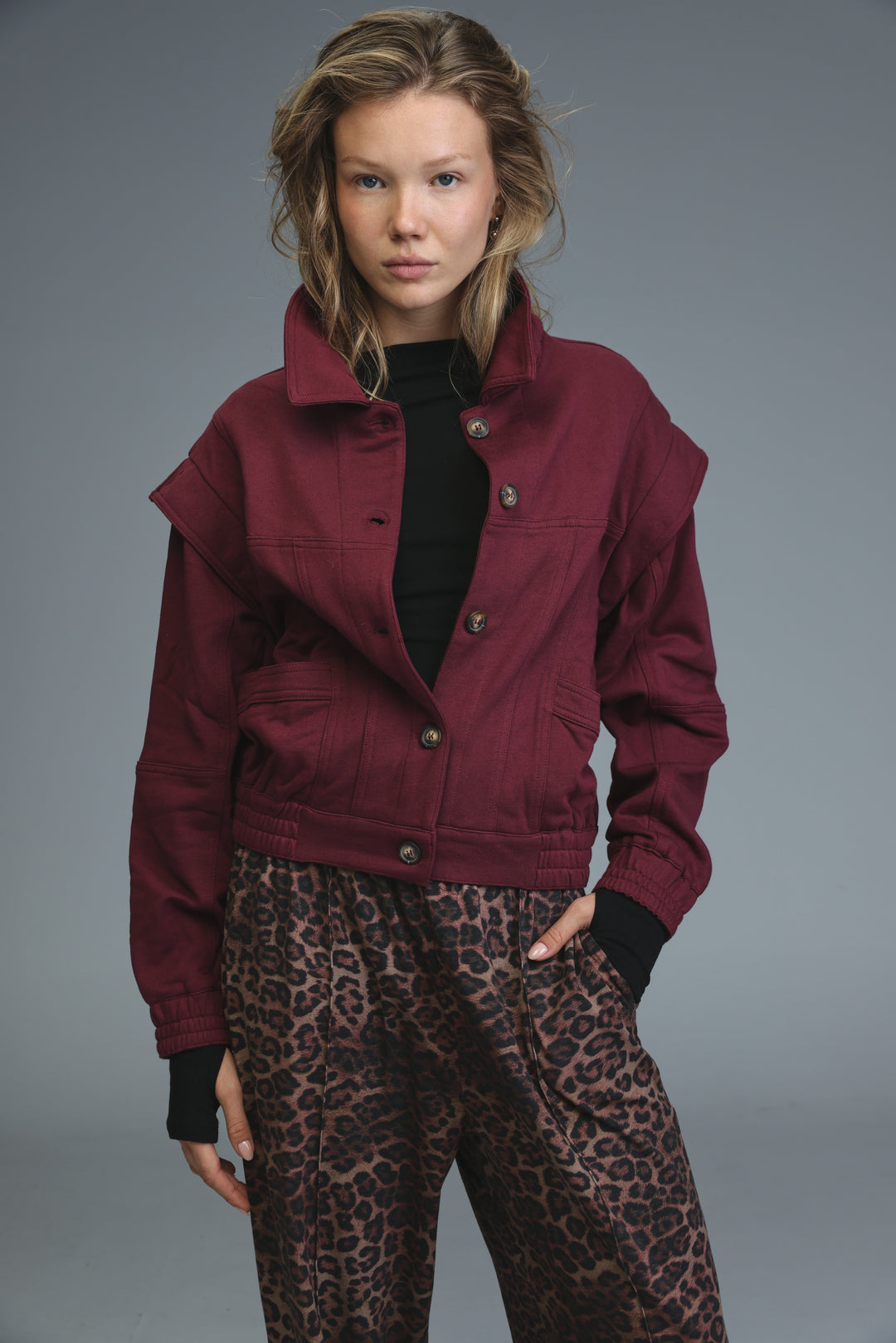 Maroon puzzle wine cropped denim jacket with collar and front button closures shown from the front