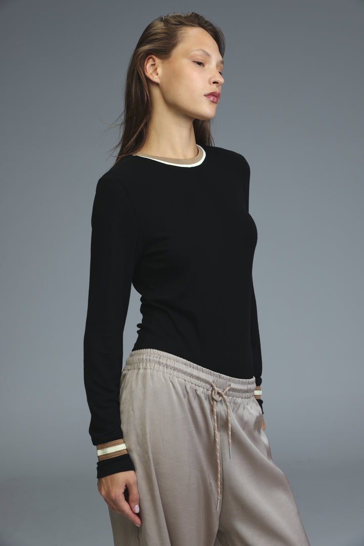 Black long-sleeved bodysuit with white trim at neckline and cuffs shown from the front