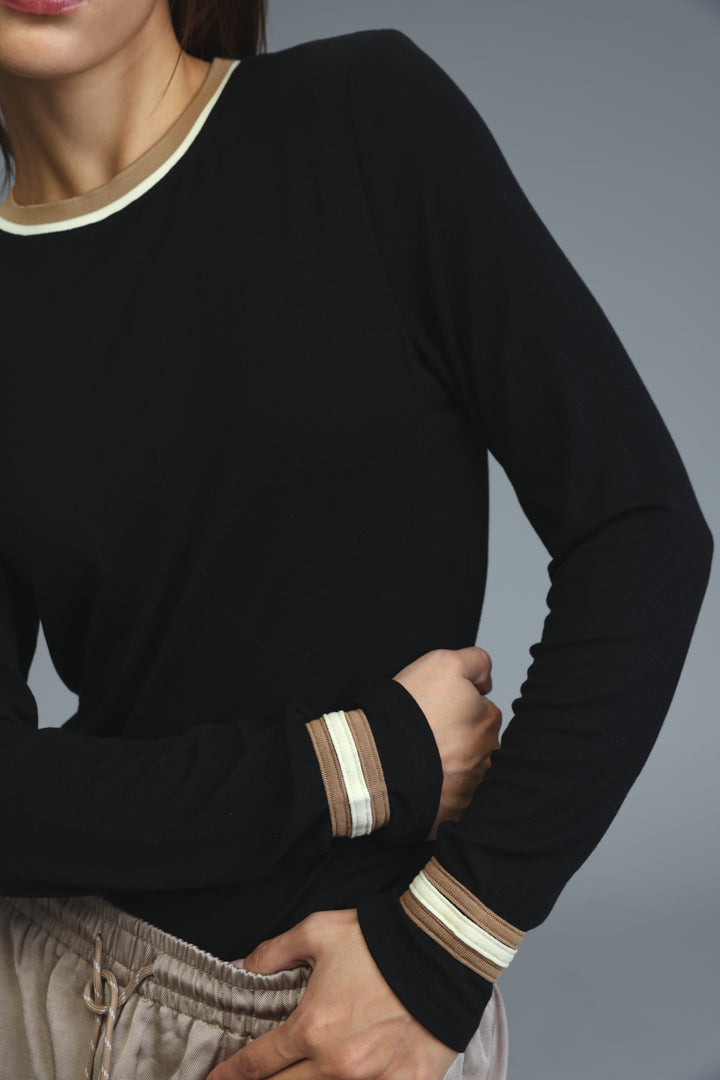 Black long-sleeved bodysuit with cream and beige striped trim at neckline and cuffs, front view