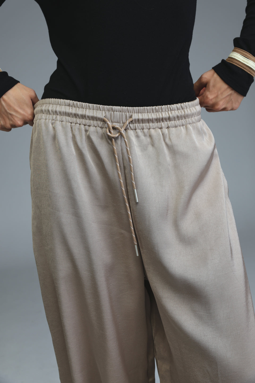 Golden camel wide-leg pants with elastic waistband and matching drawstring shown from front view