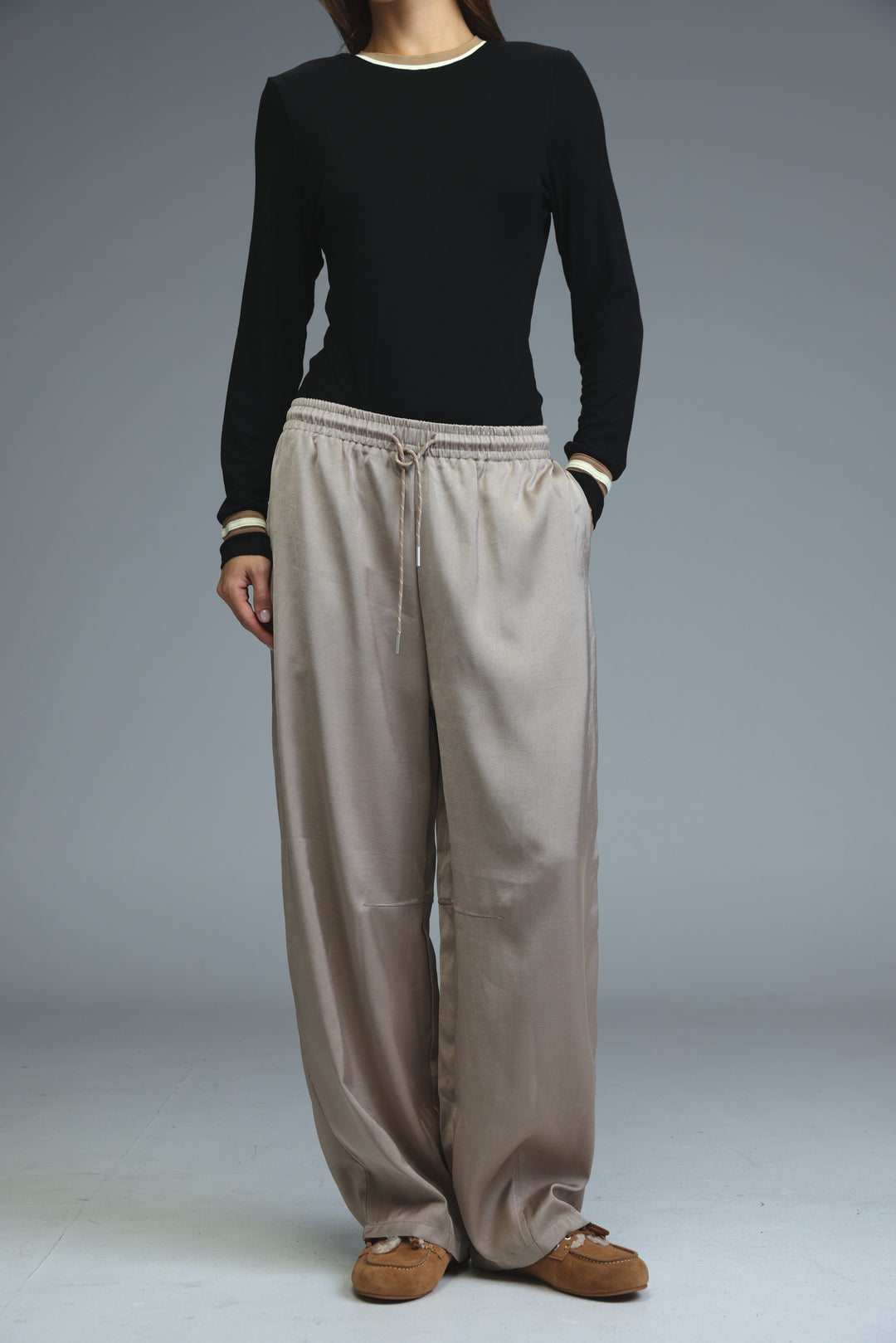 Golden camel wide-leg pants with drawstring waistband and subtle side pockets shown from the front