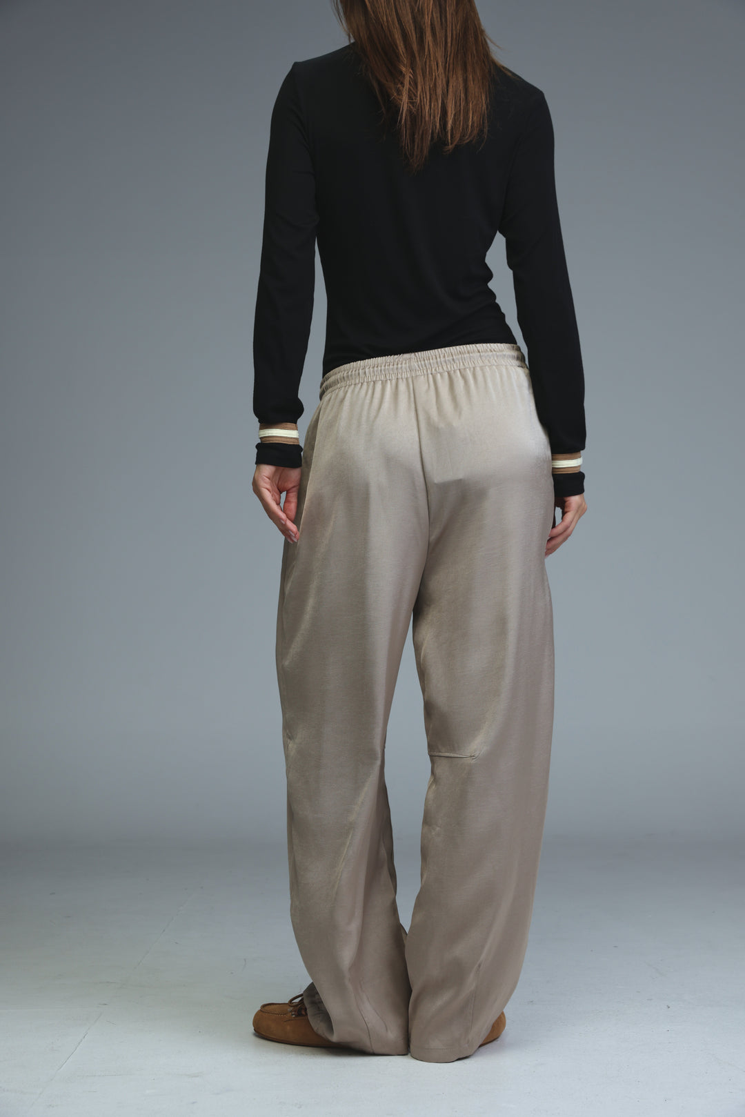 Golden camel wide-leg trousers with elastic waistband and subtle ribbed cuffs shown from the front