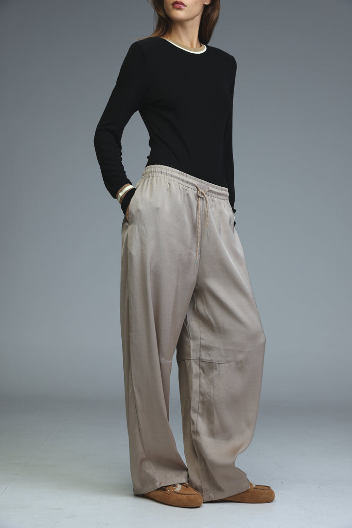 Golden camel wide-leg trousers with drawstring waist and subtle side pockets shown from the front