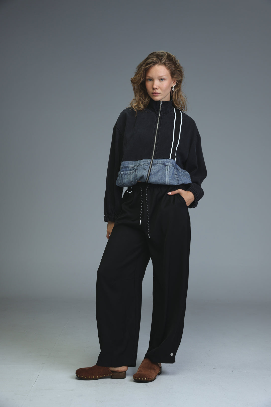 Soft denim panel jacket in black and blue with white zipper accents shown from the front