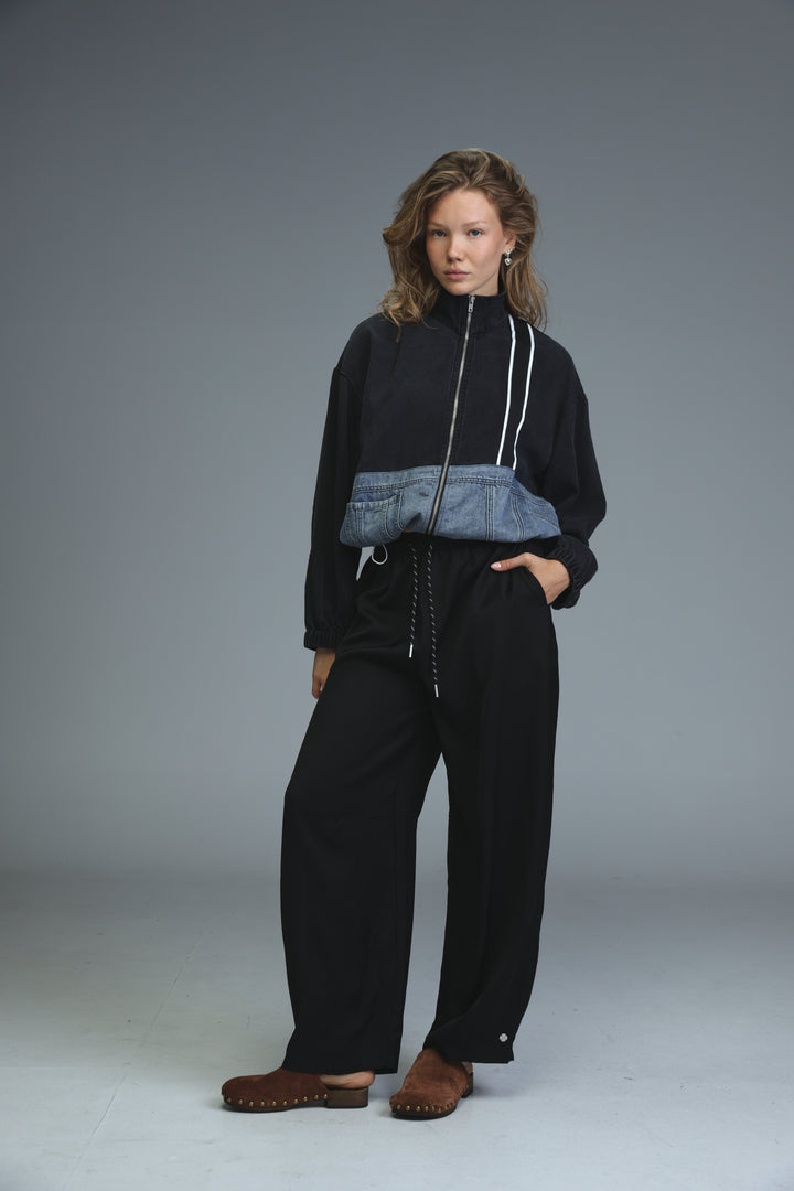 Soft denim panel jacket in black and blue with white zipper accents shown from the front