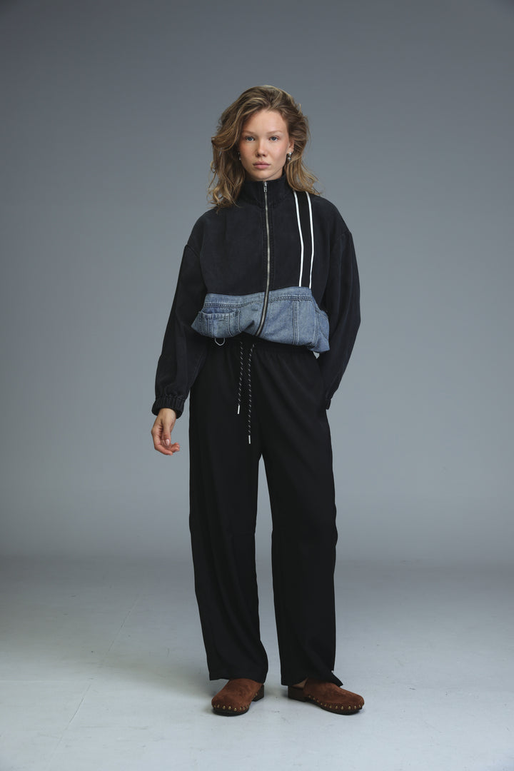Soft denim panel jacket in black and blue denim patchwork with white zipper trim shown from the front