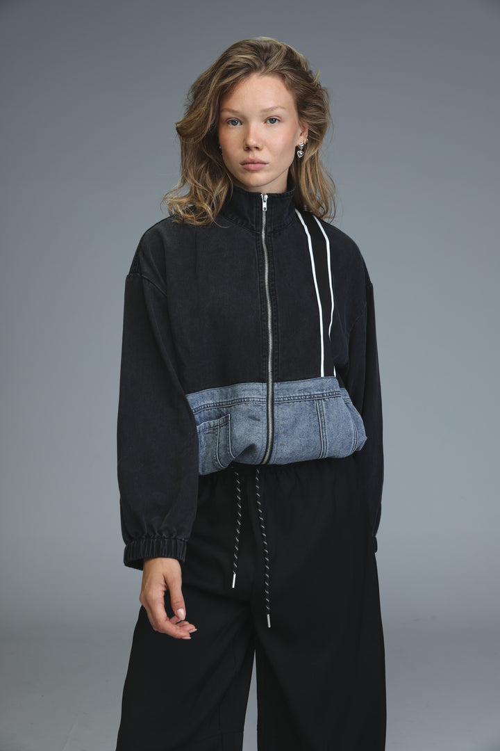 Soft denim panel jacket with black and blue denim patchwork and white zipper trim displayed from the front