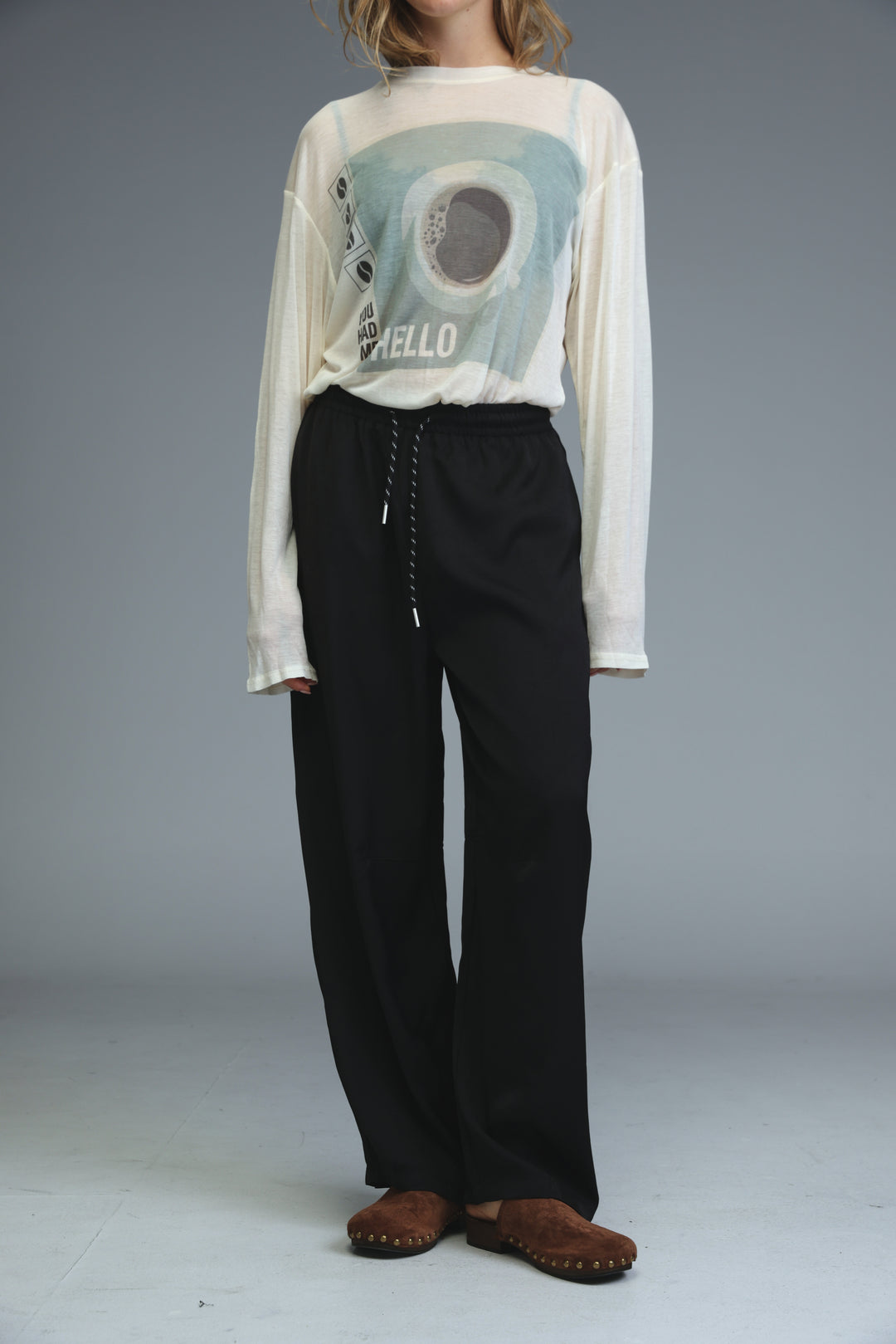 Black wide-leg trousers with drawstring waistband shown from the front in golden black bottoms product line