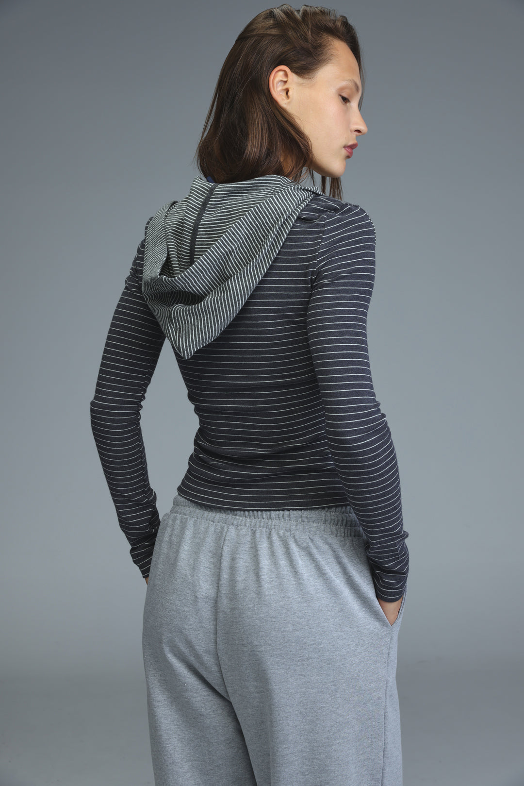Zip up brown stripes hoodie with long sleeves and matching hood shown from the front on model