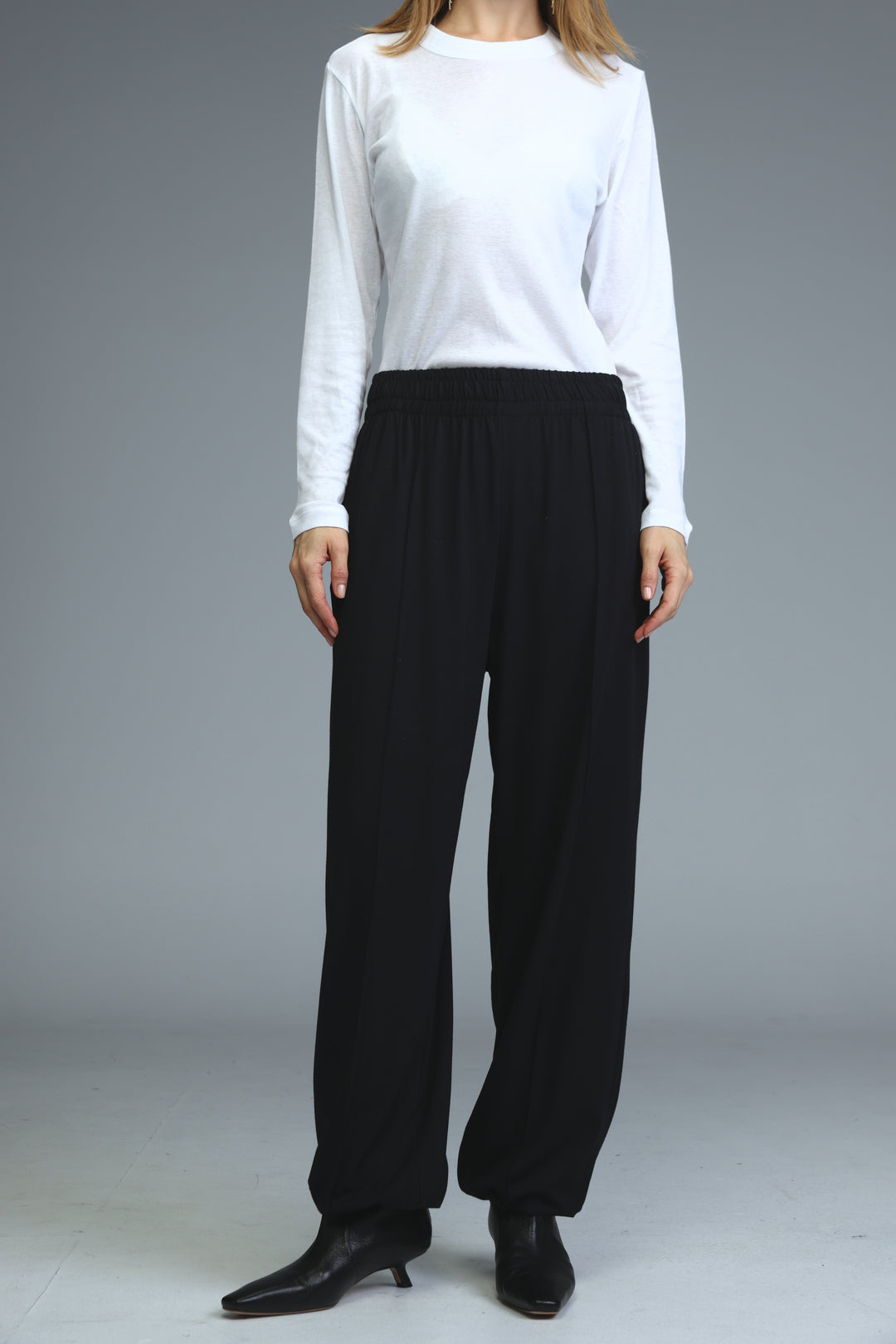 Black wide-leg joggers with a relaxed flowing silhouette and elastic waistband shown from the front view