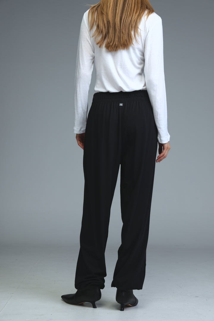 Black high-waisted joggers with a sleek straight-leg cut and subtle pleats at the back shown from the back view