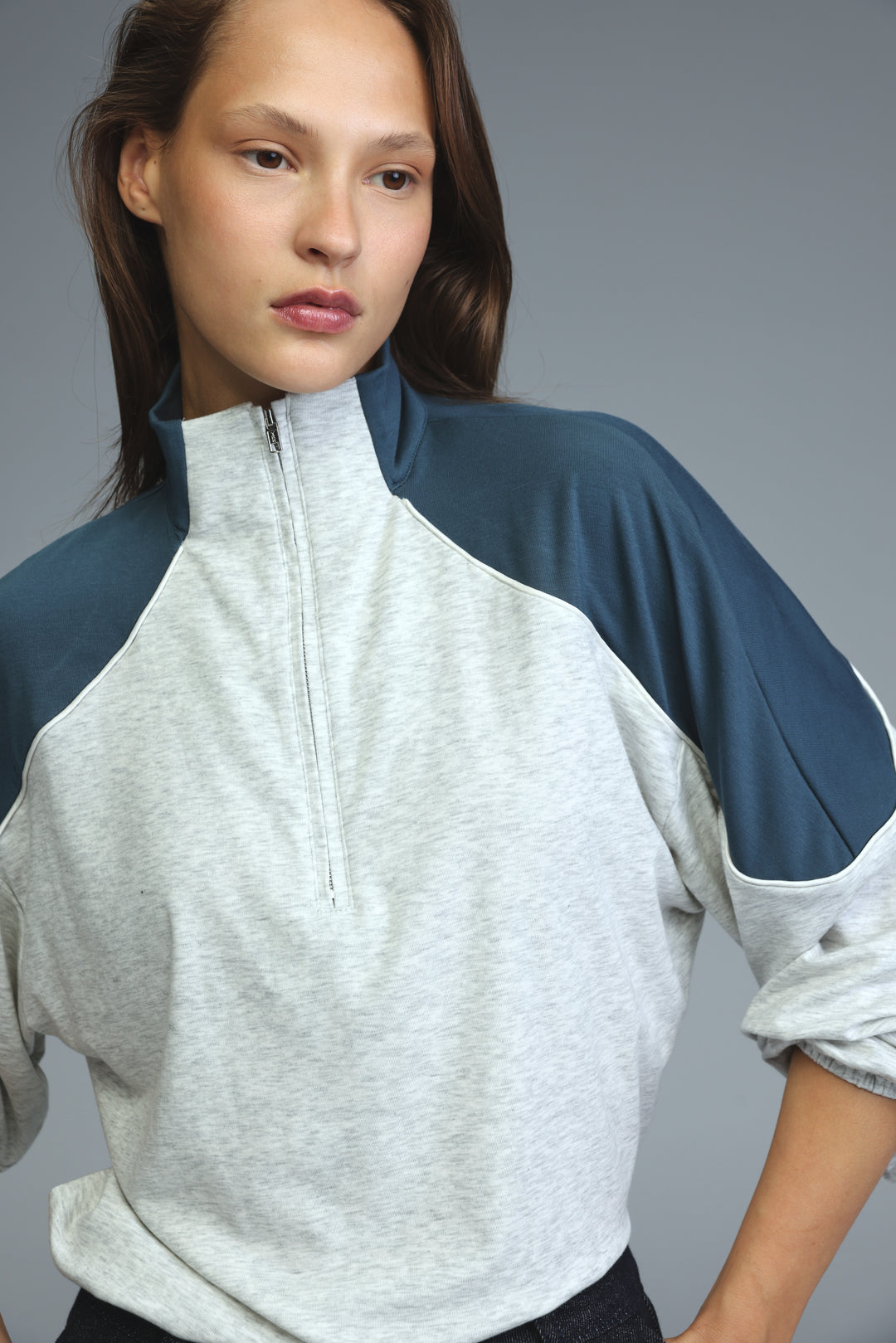 Allure grey sweatshirt with heather gray body and navy blue raglan sleeves front view featuring half-zip detail