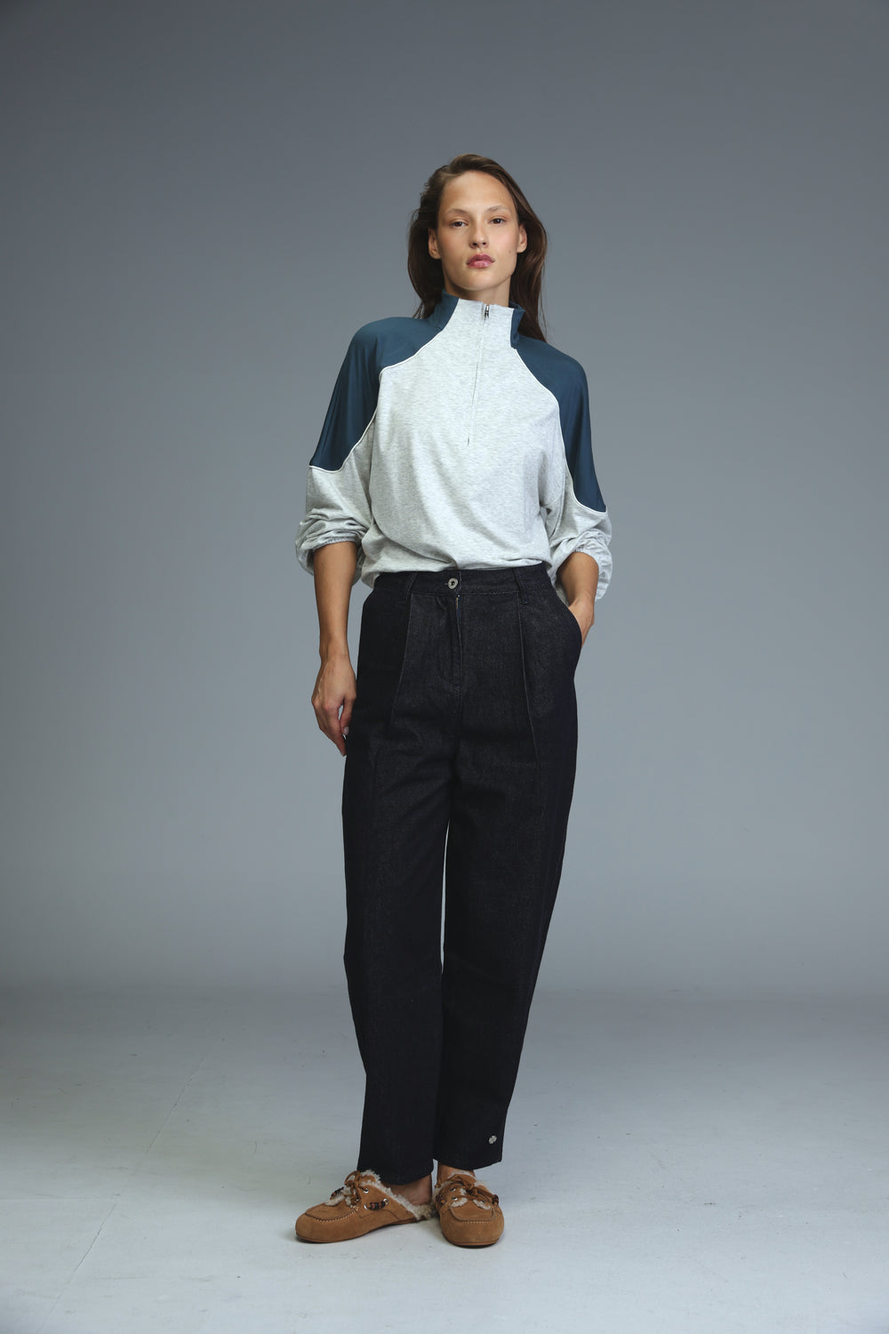 Woman wearing a star 250 dark blue tailored denim jacket with navy blue sleeves and white body, front view