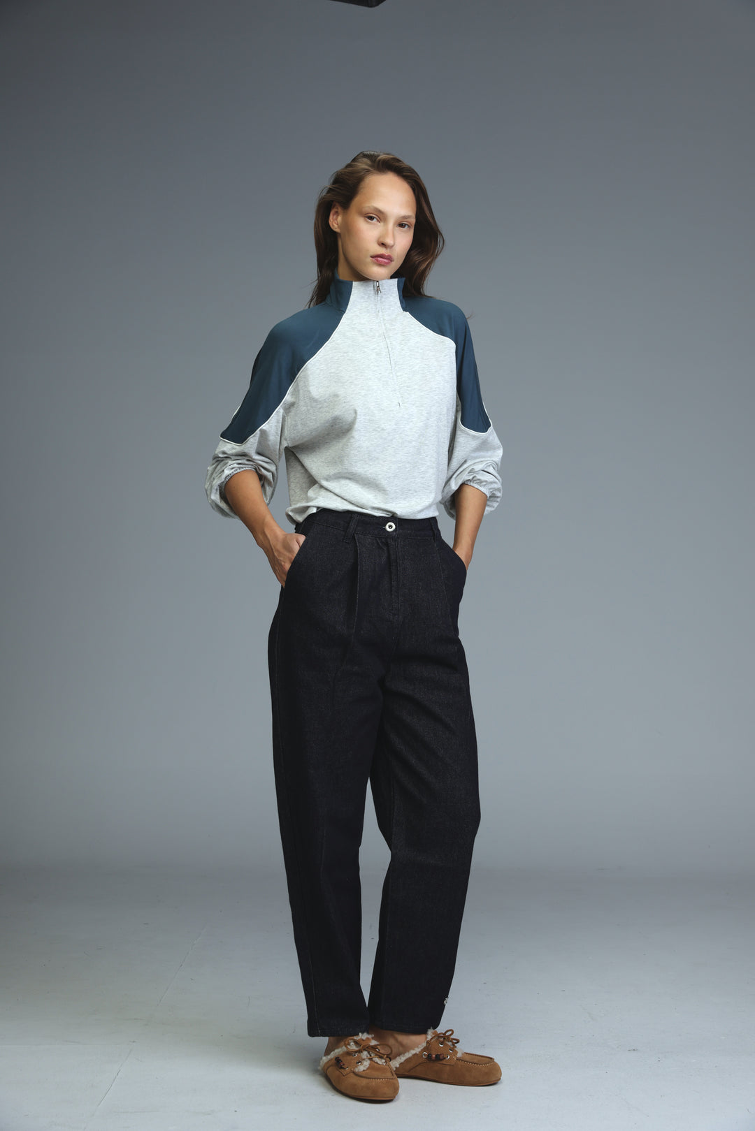 A front view of a star 250 dark blue tailored denim two-tone zip-up top with navy sleeves and light gray body