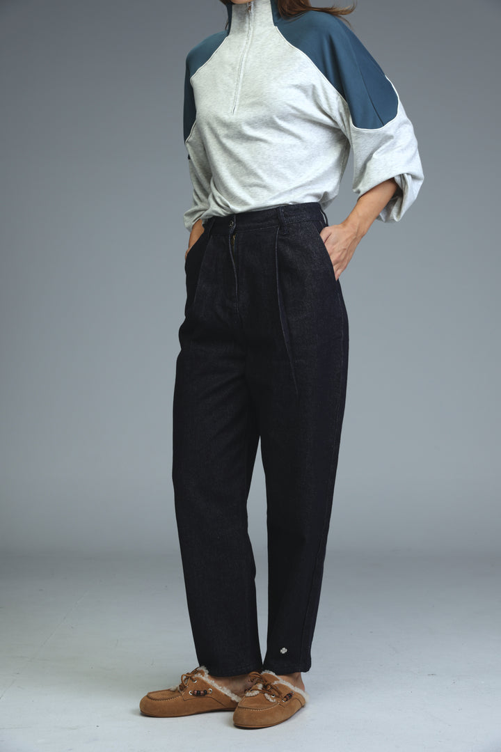 Dark blue tailored denim high-waisted trousers with a relaxed fit and pleated front shown from the front view