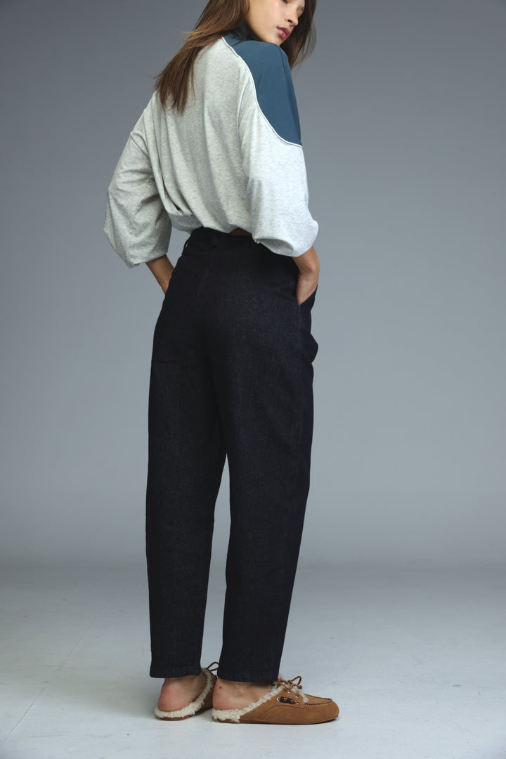 Dark blue tailored denim wide-leg trousers with relaxed fit and subtle creases, front view