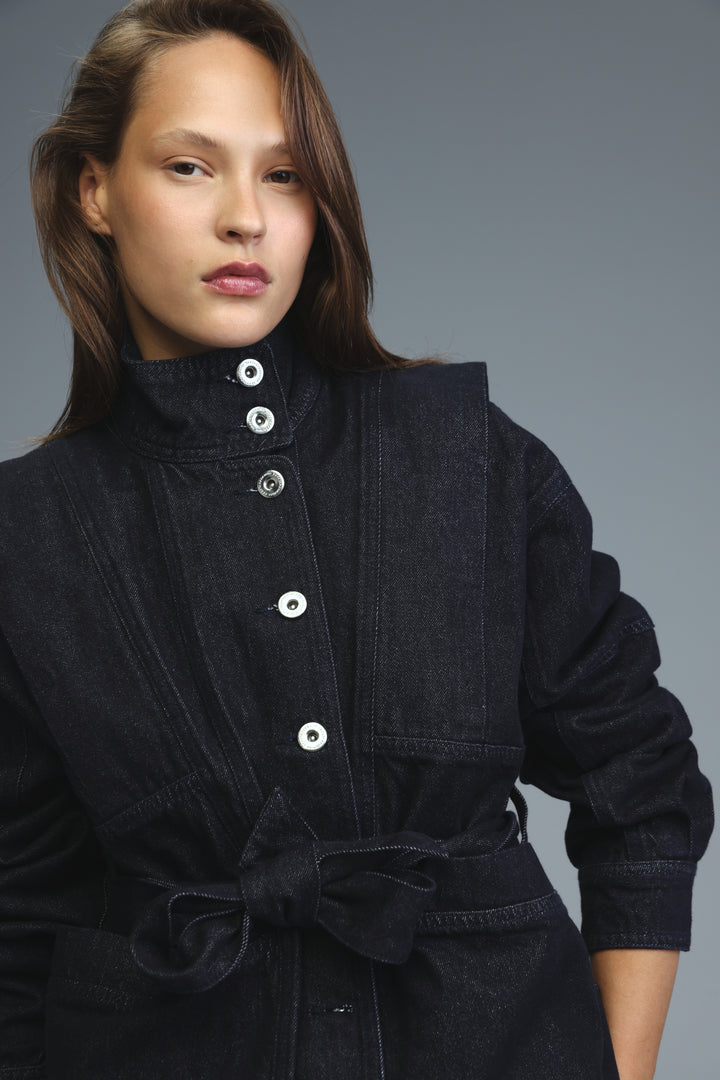 Prestige dark blue denim jacket front view with high collar, silver buttons, and tied waist belt