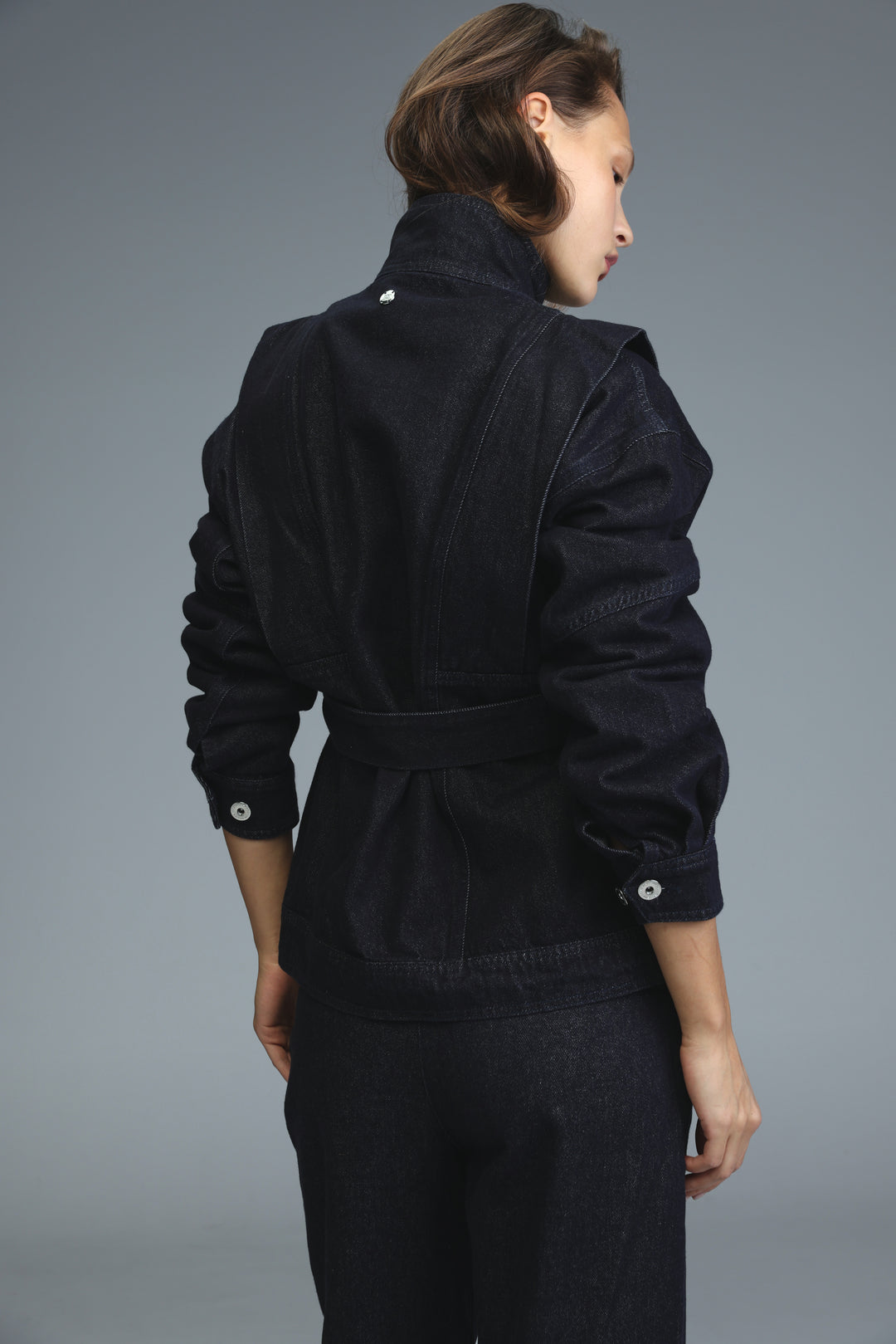 Prestige dark blue denim jacket with puffed sleeves and belted waist shown from the front