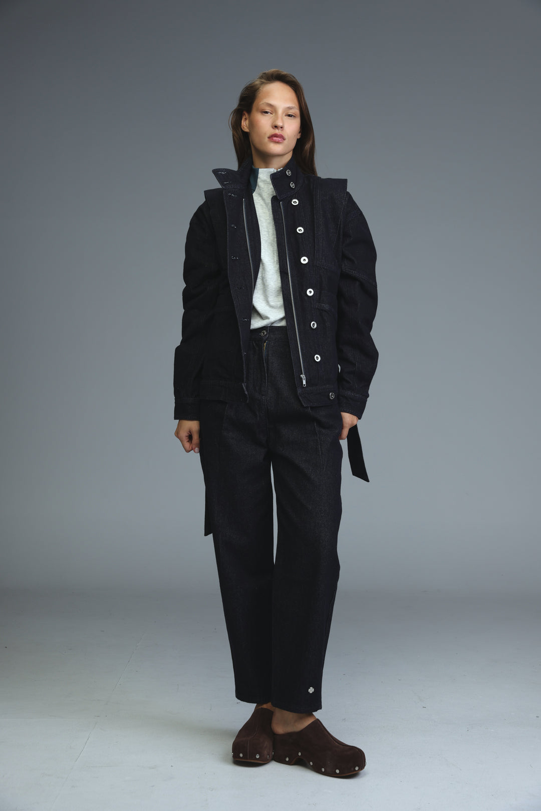 Prestige dark blue denim jacket with front view worn over black utility jacket with white buttons and hood