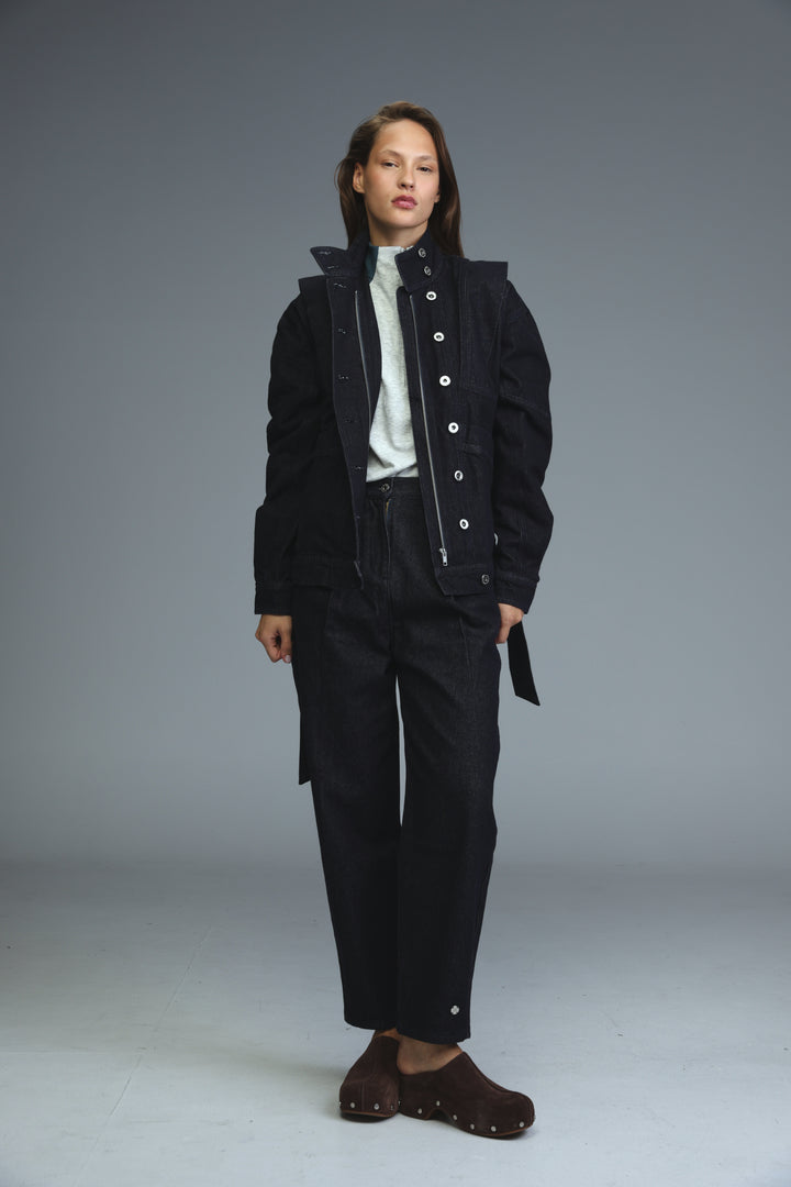 Prestige dark blue denim jacket with front view worn over black utility jacket with white buttons and hood