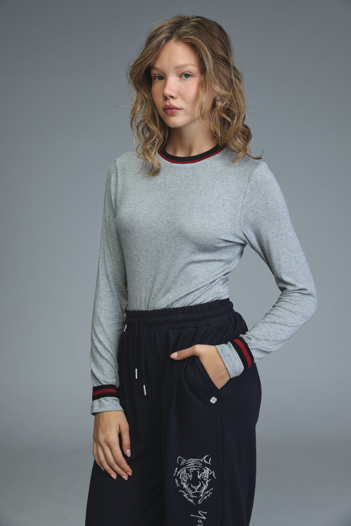 Gray long-sleeved bodysuit with black ribbed trim and red accent stripes at the cuffs, front view