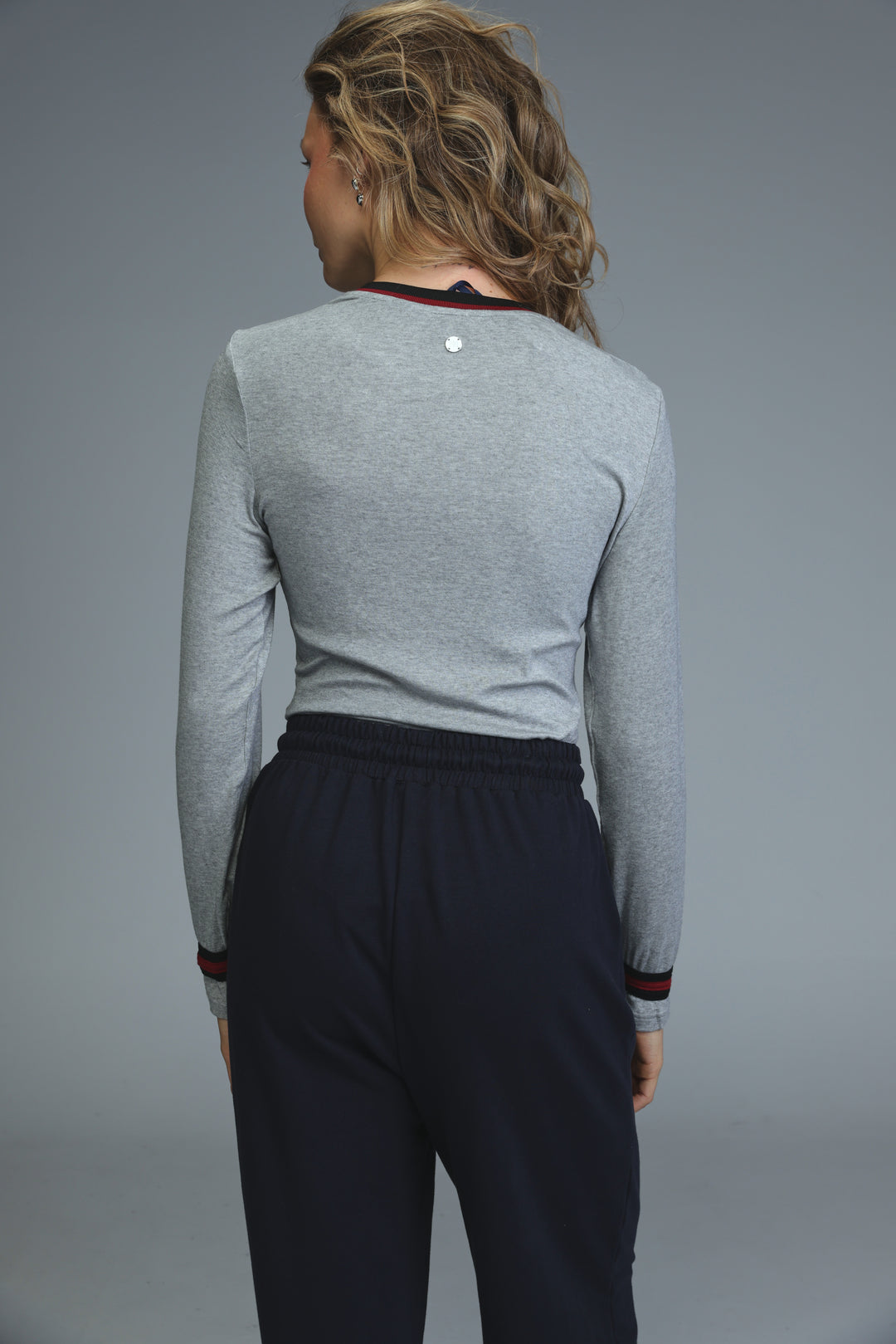 Trim grey bodysuit long-sleeved top with black trim at neckline and cuffs and a small silver button on the back