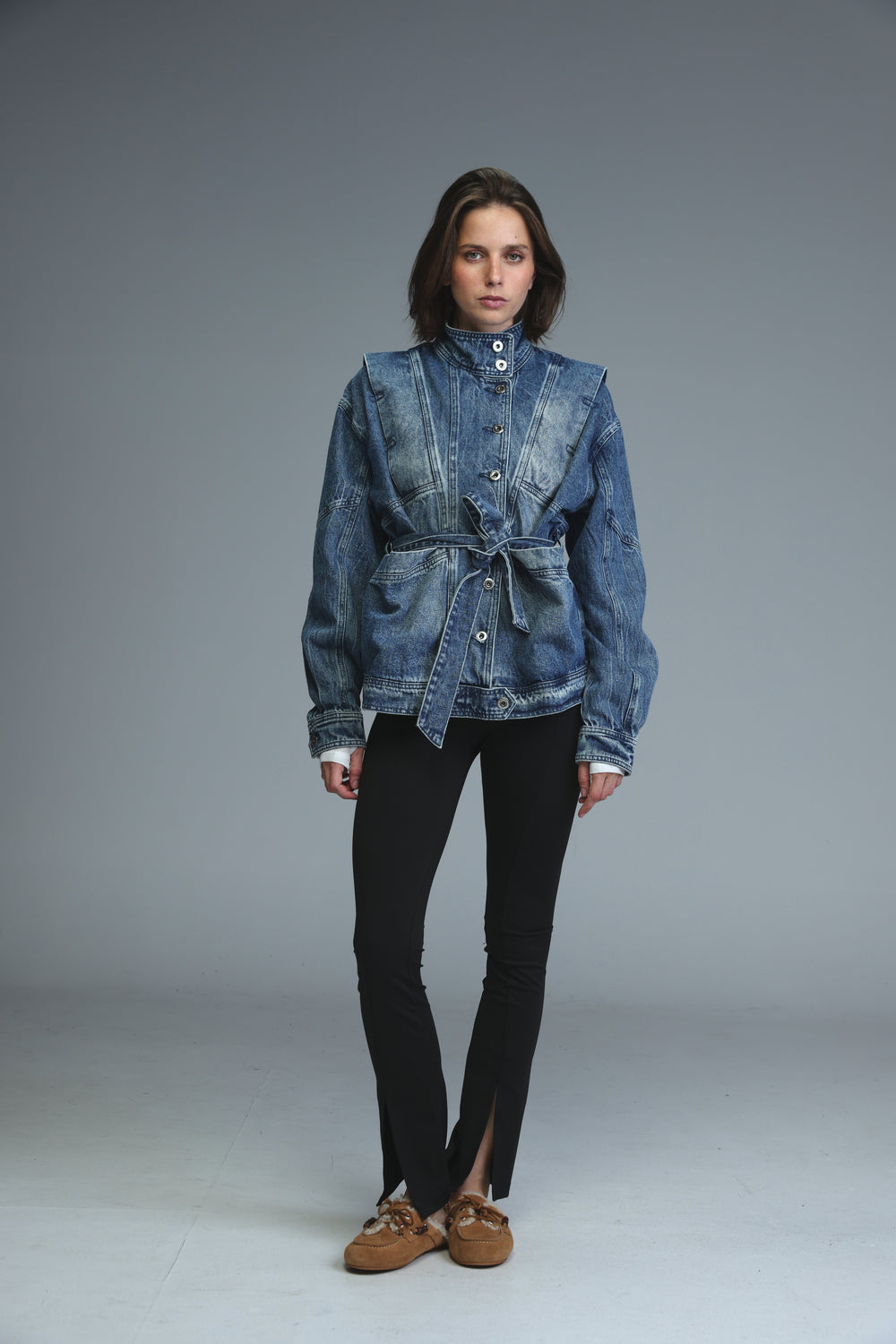 Prestige blue denim jacket with belted waist and buttoned front shown from the front view