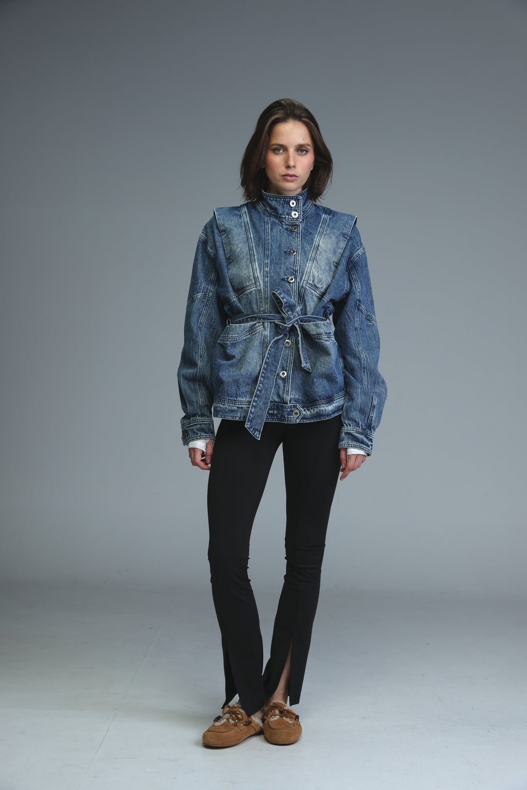 Prestige blue denim jacket with belted waist and buttoned front shown from the front view