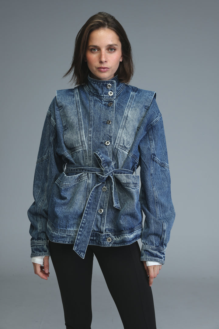 Prestige blue denim jacket with high collar, front button closure, and belted waist shown from the front view