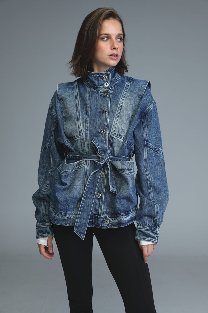 Prestige blue denim jacket with high collar, front button closure, and tied waist belt shown from the front